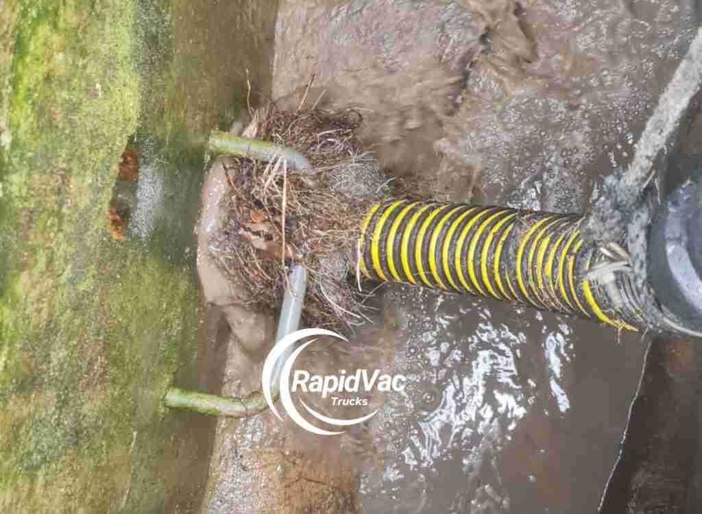 Vacuum truck clearing blocked sewer lines for efficient waste management.
